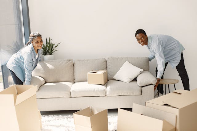 A Young Couple Picking up a Couch Together