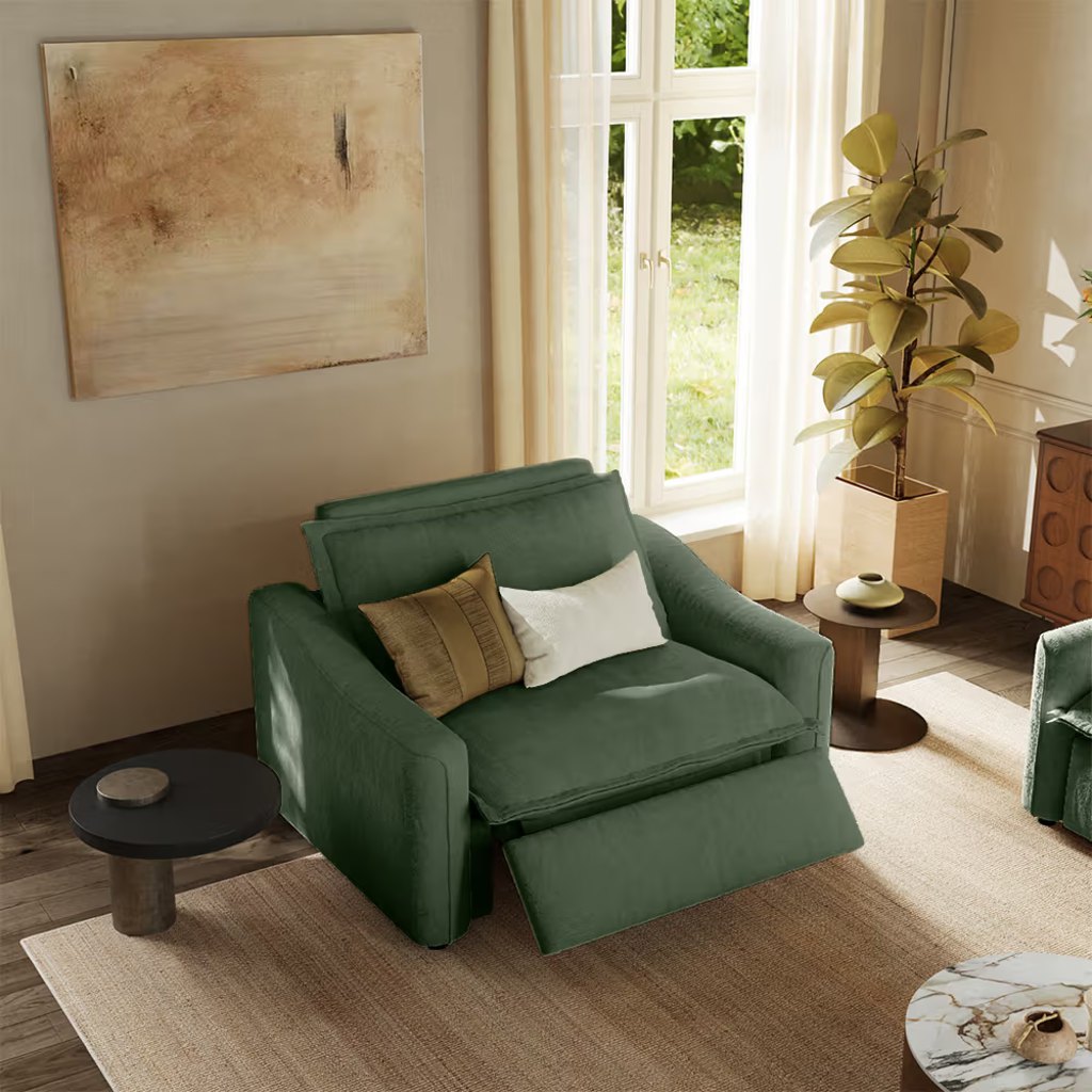 Green oversized power recliner with an extended footrest and adjustable headrest in a warm modern living room.