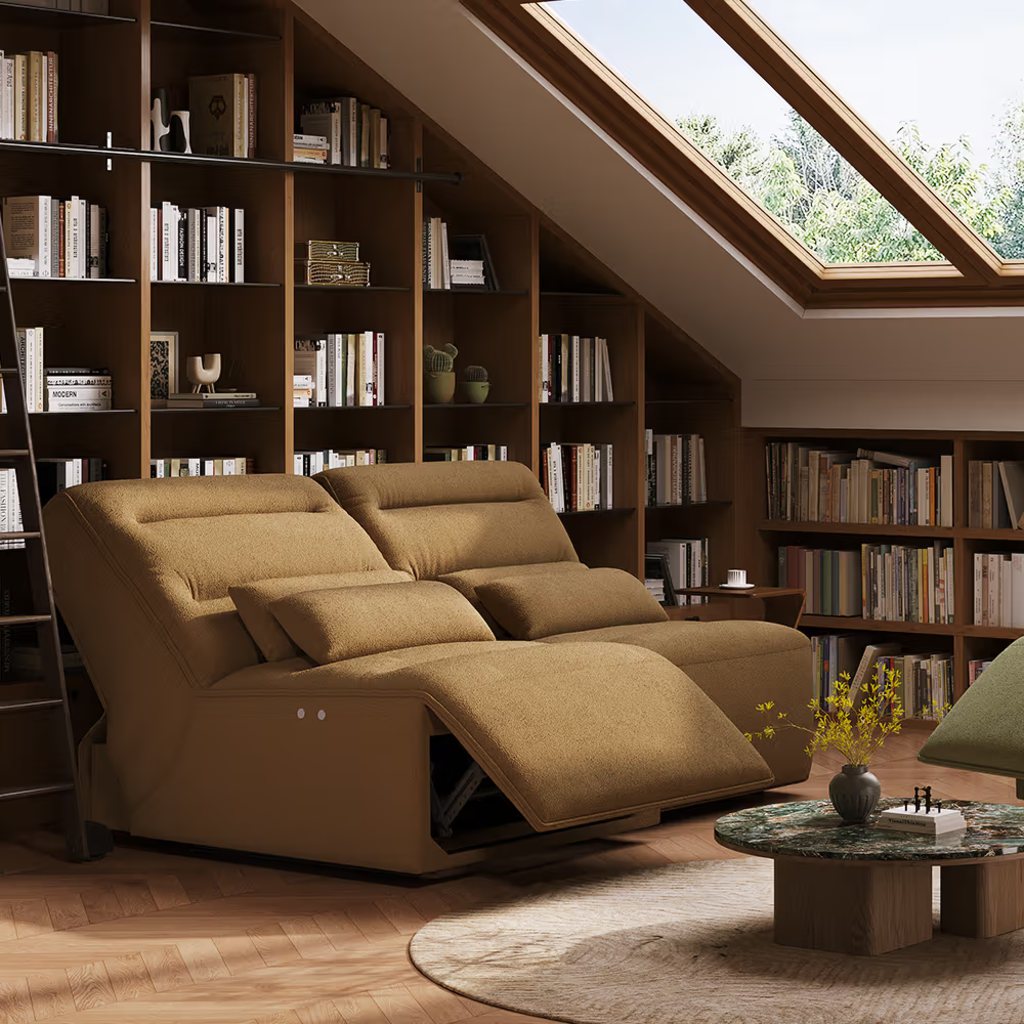 Brown power reclining loveseat with extended footrests and adjustable headrests in a warm home library.