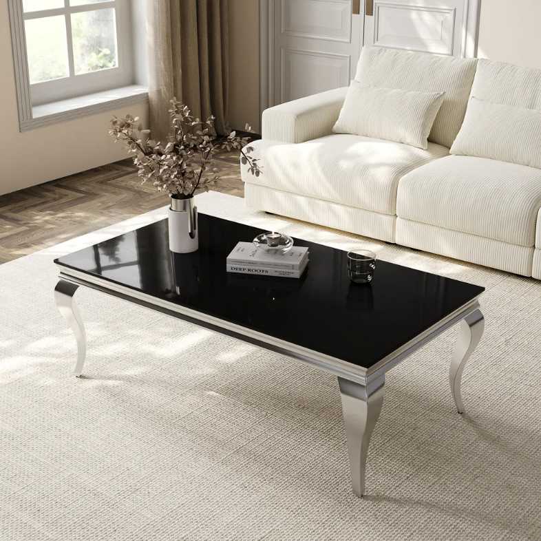 a short and small, rectangular, black glass coffee table with decorations on top