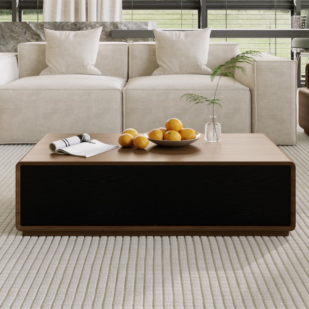 Rectangular walnut coffee table with black storage drawers in front of a cream sofa in a bright modern living room.