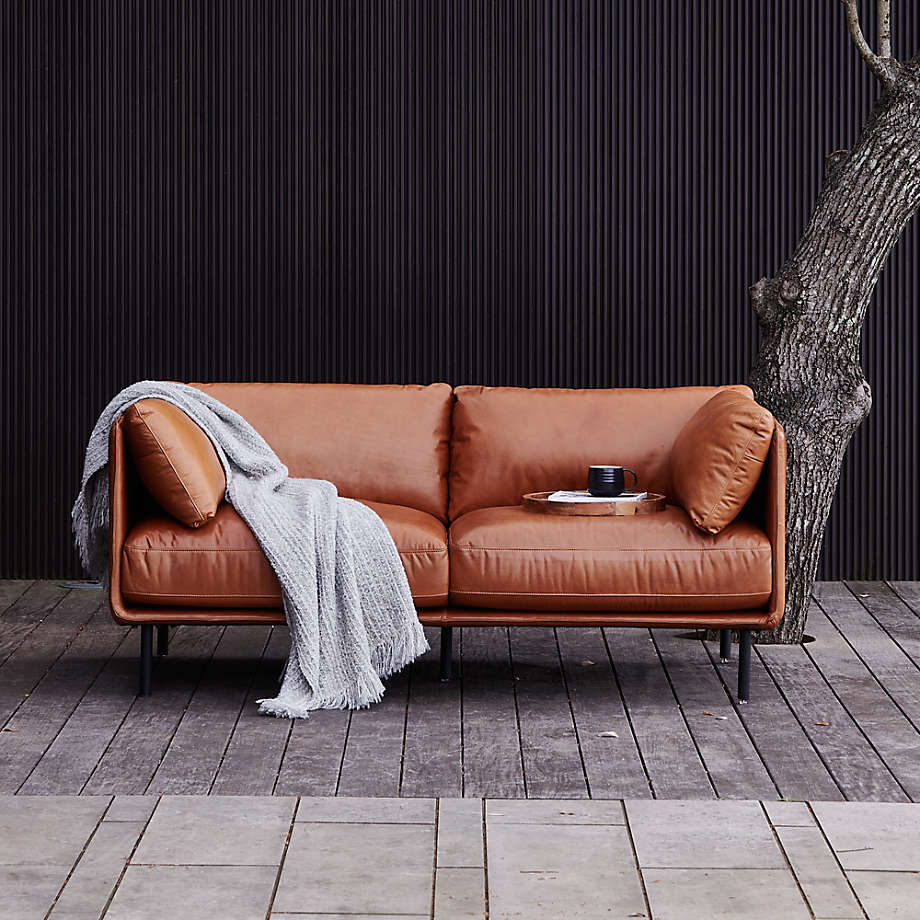 a small brown leather loveseat fit in a compact living room