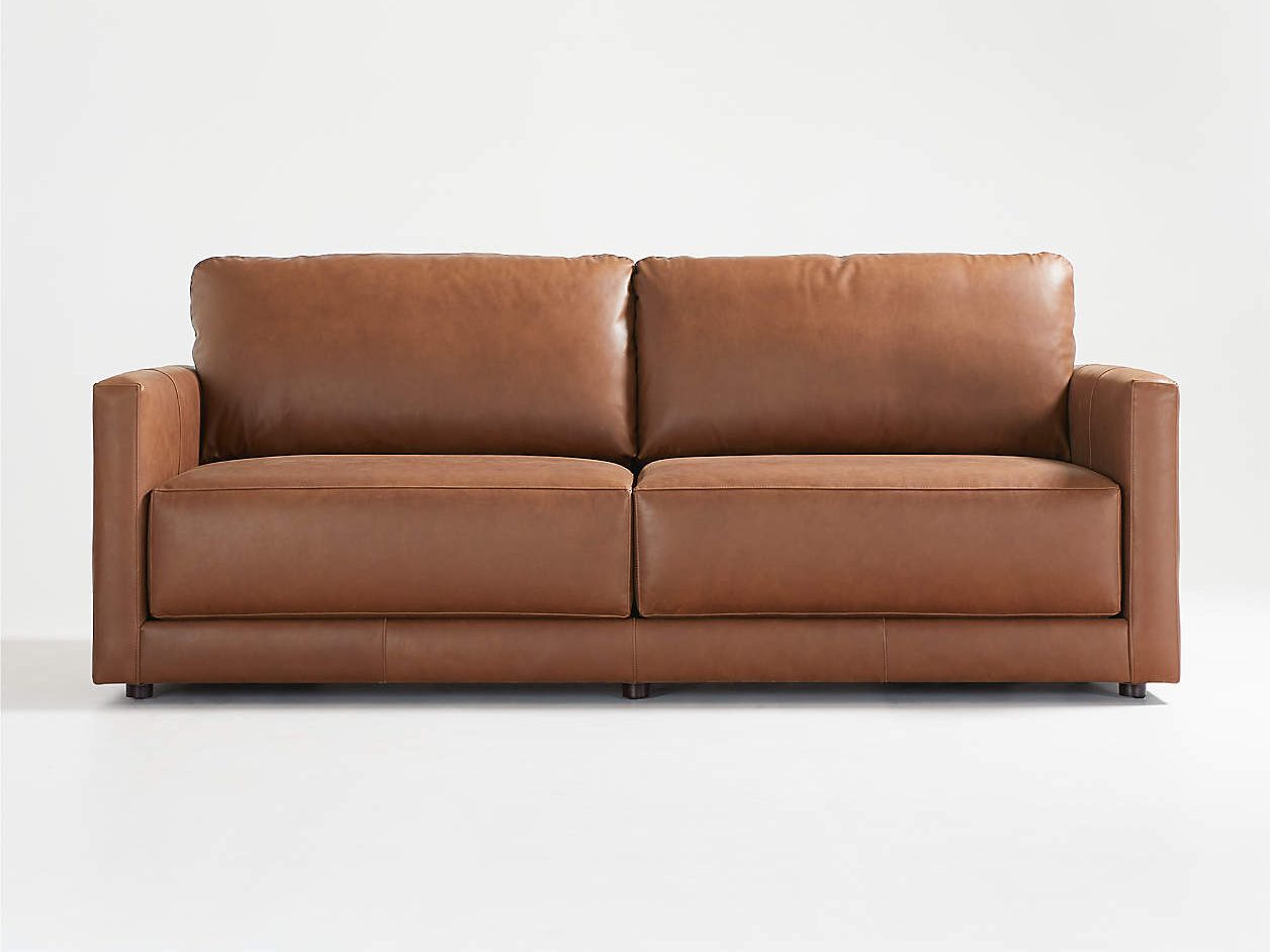 a tan colour-like leather sofa fit in a bright living room