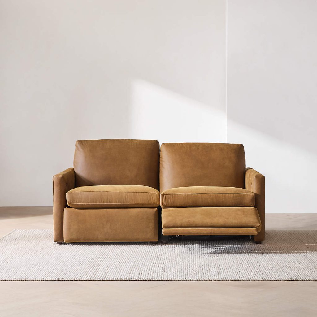 a brown leather reclining sofa in a bright and cozy living room under the sunlight
