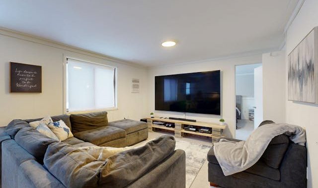 Modern Living Room with Large TV and Sectional Sofa