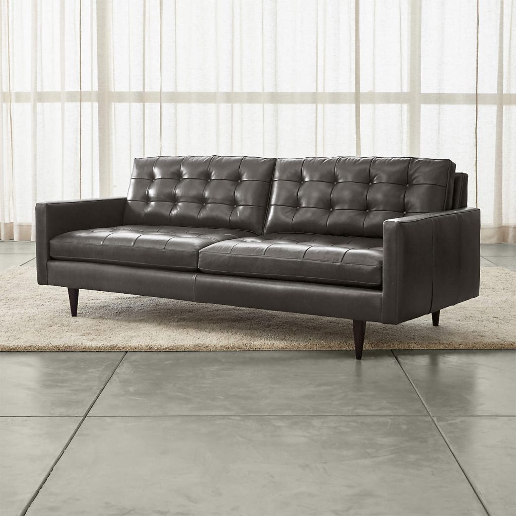 a mid-century black leather sofa for living rooms in modern decoration