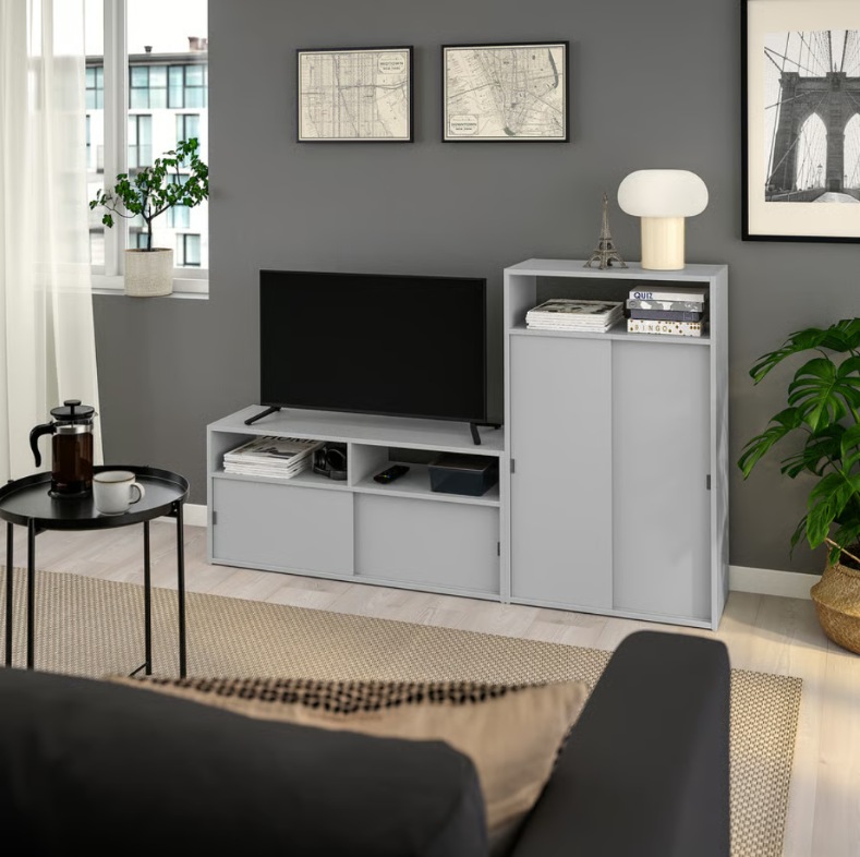 a small and tiny tv stand with storage and decorations fit in a small living room or apartment