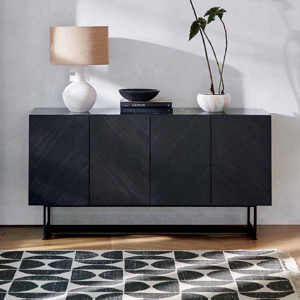a black wood tv console with books, a plant and a lamp on top in a modern style for contemporary decoration
