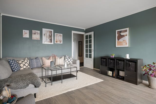 a glass coffee table slightly higher than the sectional sofa