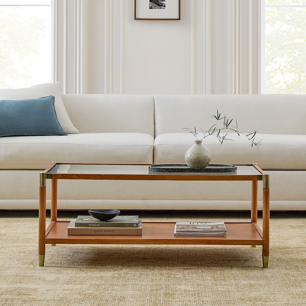 a rectangular coffee table with crystal glass and walnut wood, capable for decorations and storing books