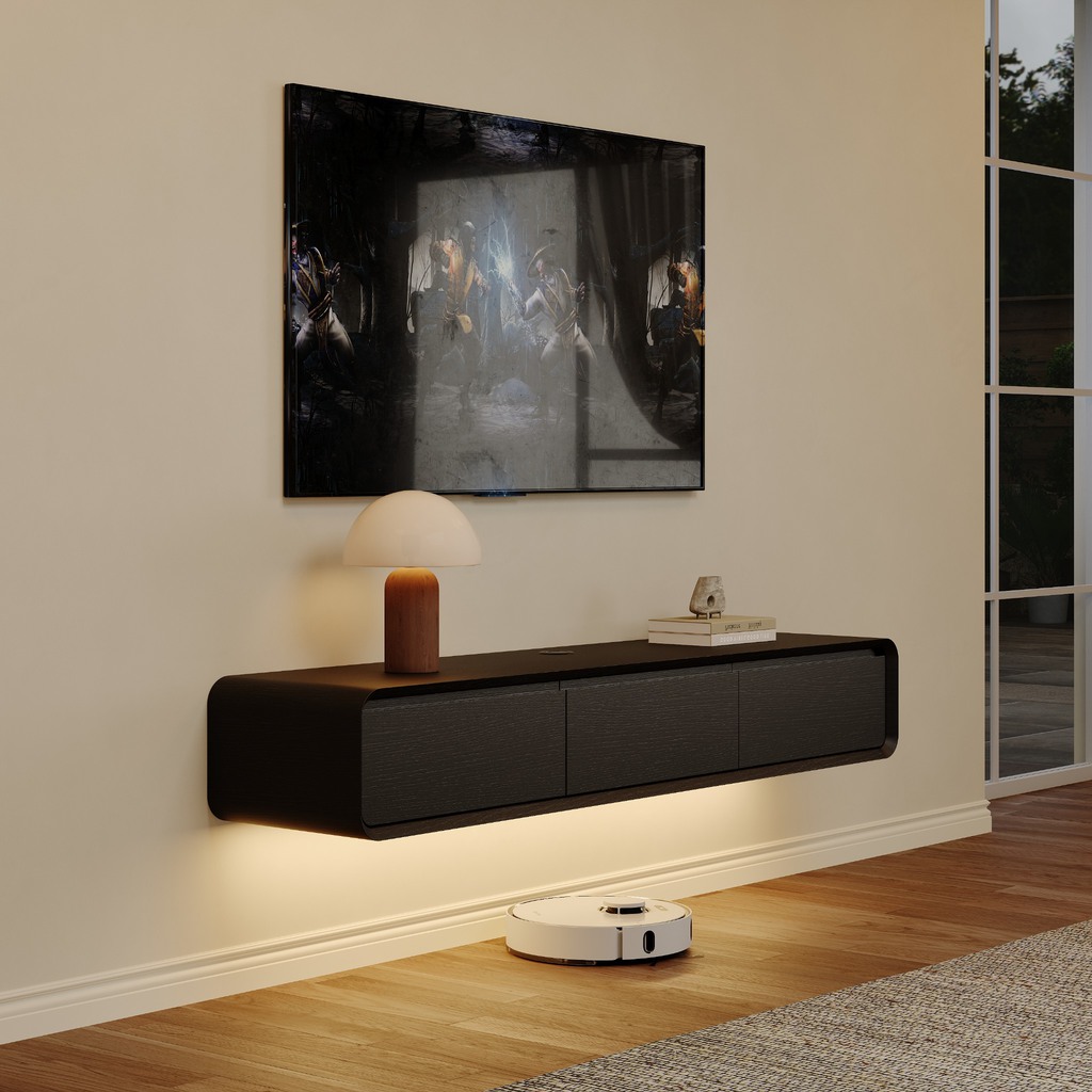 Black floating media console mounted below a wall-mounted TV, with warm under-cabinet lighting in a modern living room.