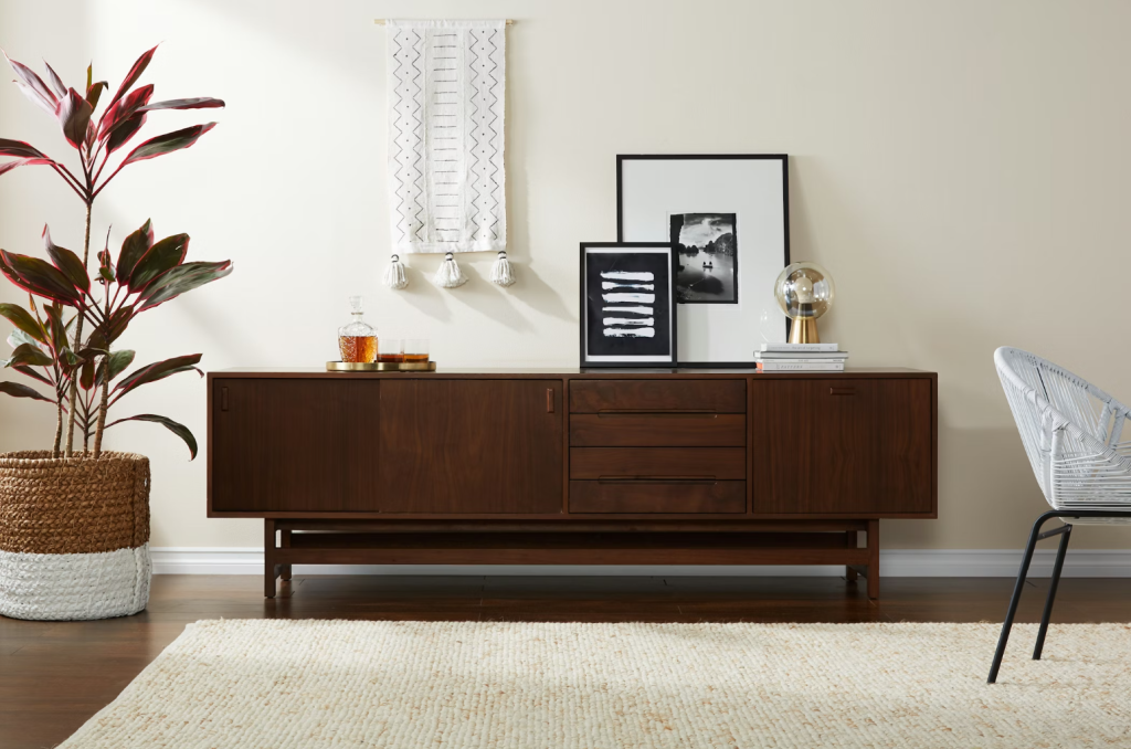 a brown wooden tv stand for large tv or media console with decorations on top