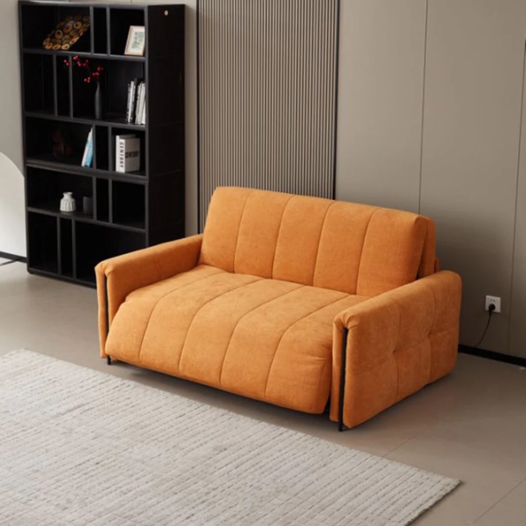 Orange two-seat power sofa bed with channel-tufted upholstery in a compact modern living room.