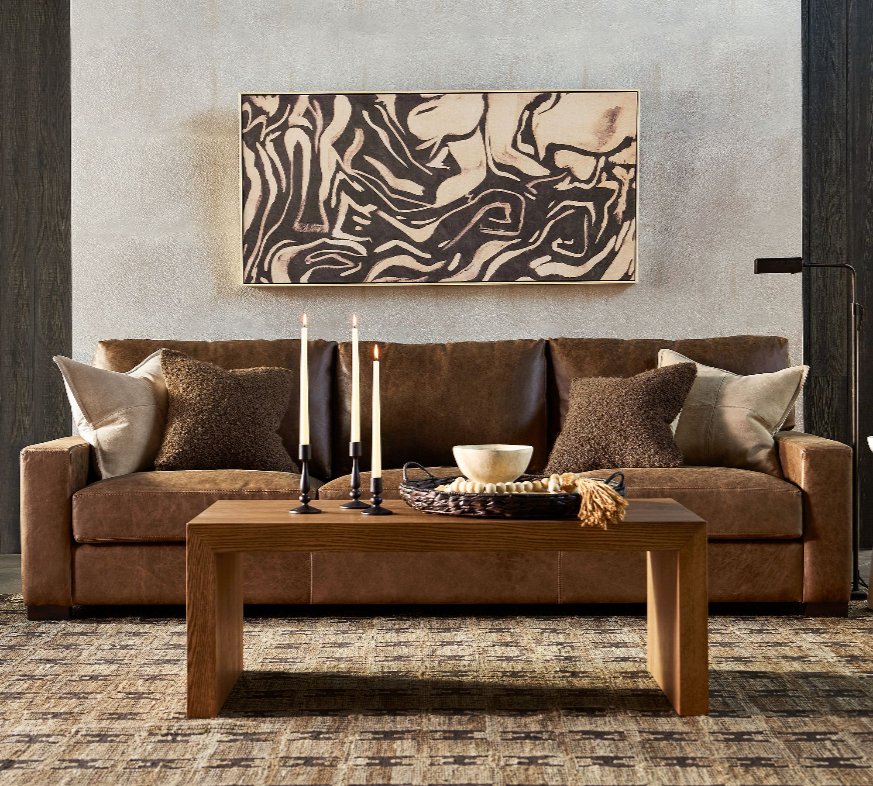 Pottery Barn Turner Square Arm  brown Leather Sofa with cushions on top near a wood coffee table in a modern living room