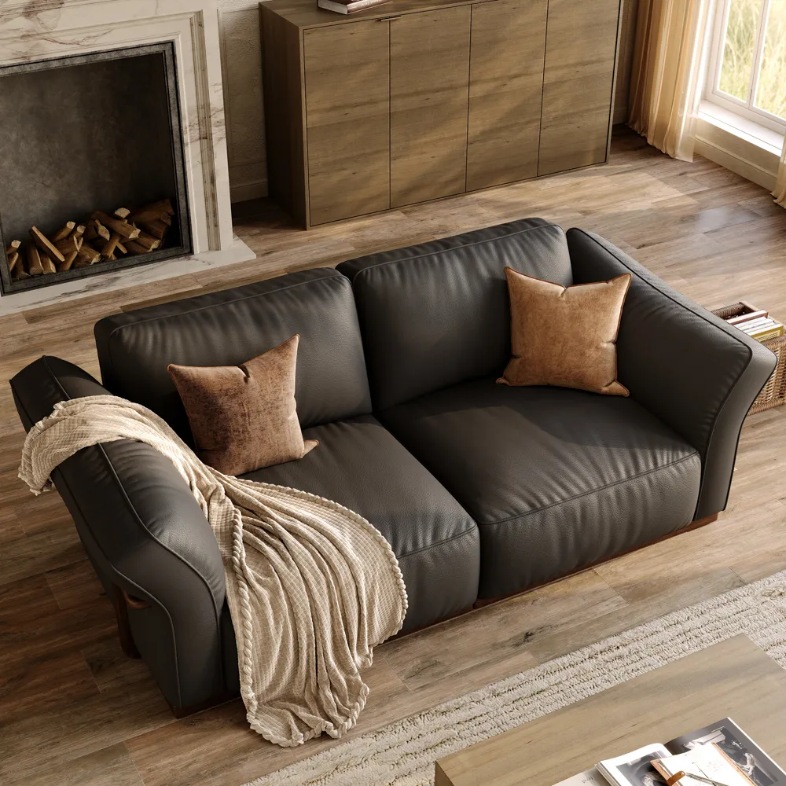 a modular black leather sofa with cushions in a living room