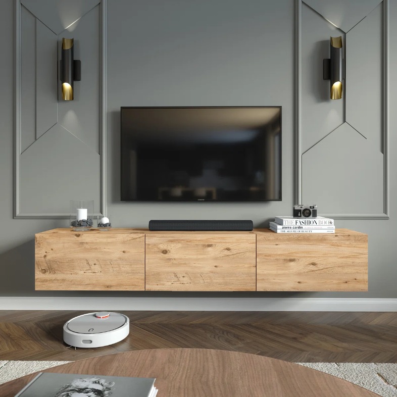 a wood floating media console with books and decorations on top and a tv above in a modern living room