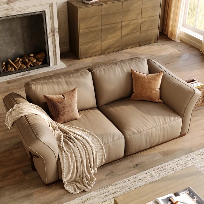 a tan-like khaki colour leather sofa in a bright living room with cushions 