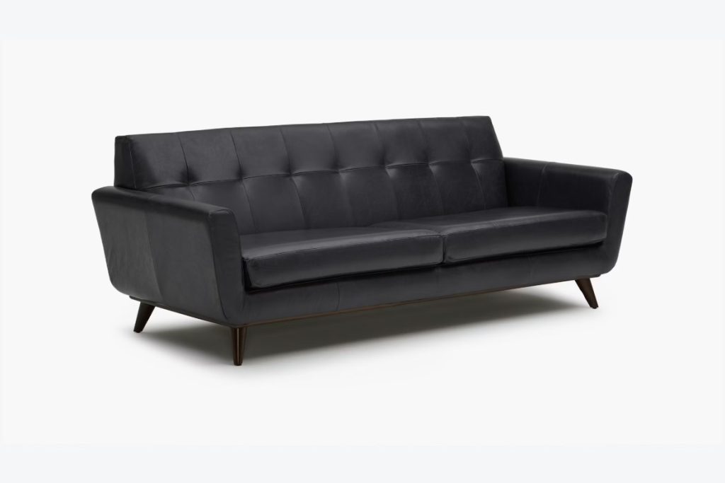 a black leather sofa in mid-century style for modern living rooms