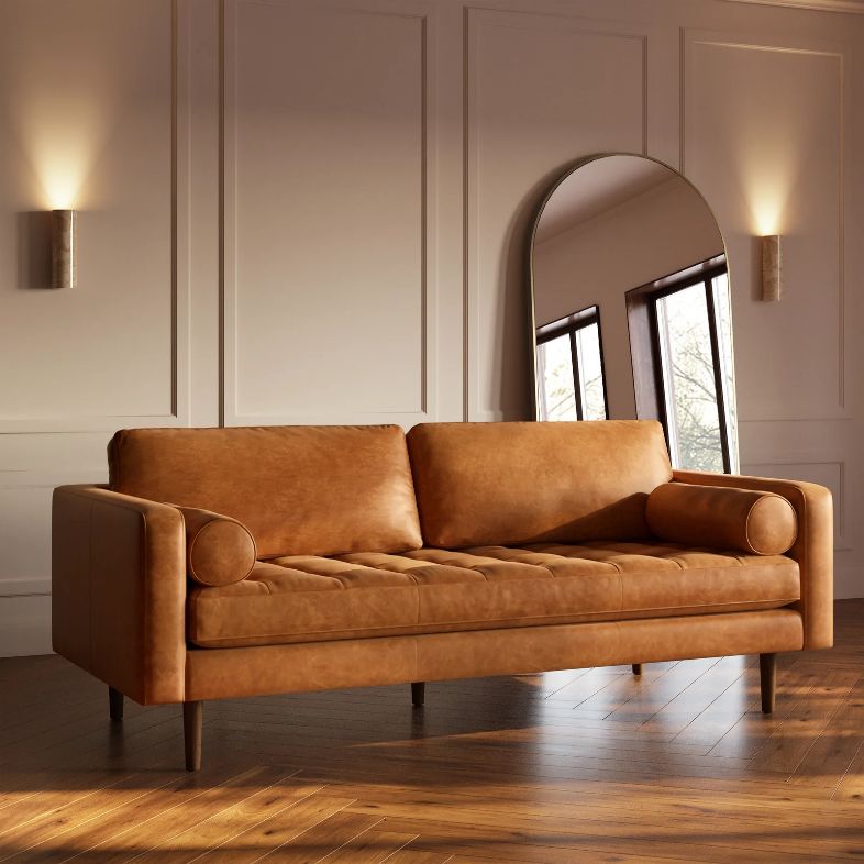 a brown leather sofa in a cozy and modern living room