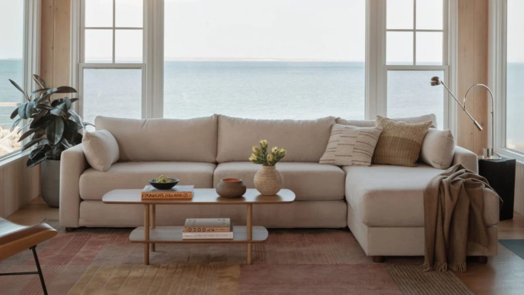 a leather sleeper sofa near a coffee table in a bright and modern living room