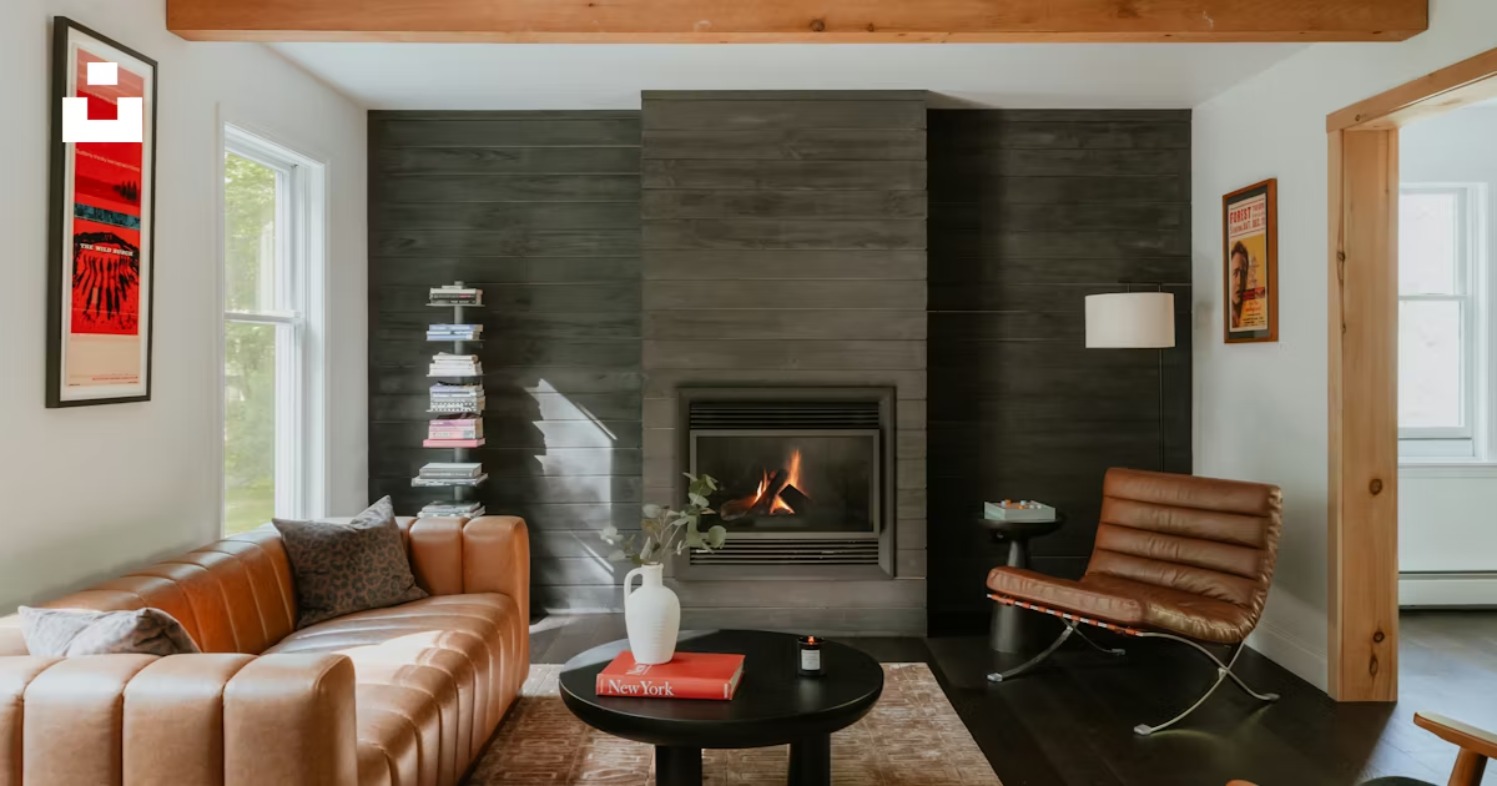 Brown 3 seater leather sofa in a modern living room with fireplace