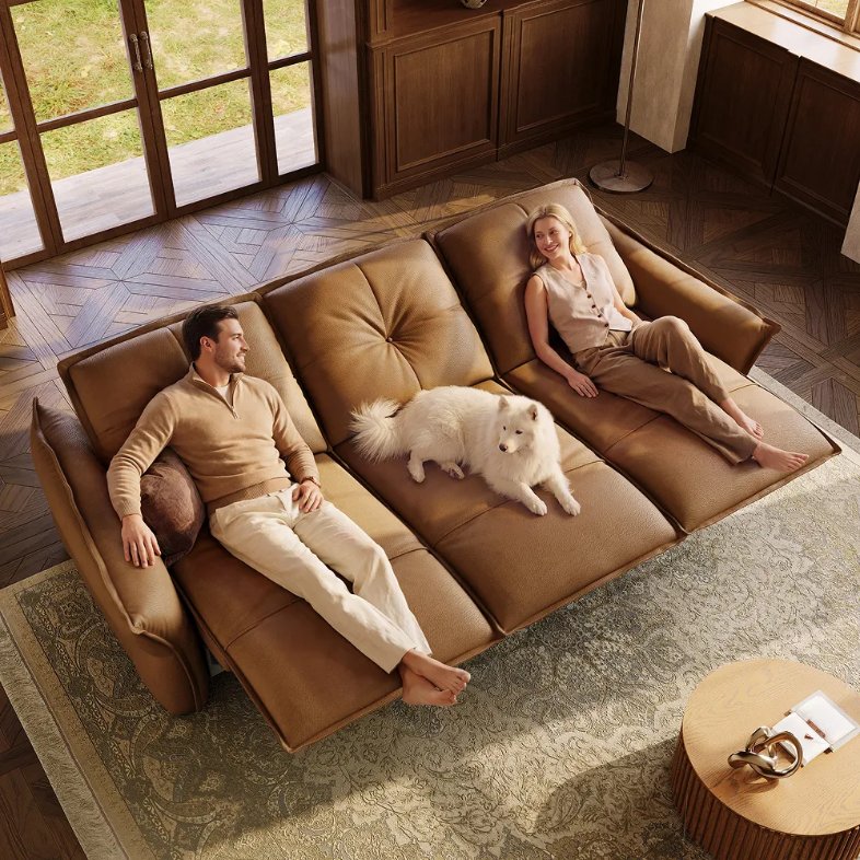 Povison Marlowe-Dual Power Reclining Leather Sofa with a couple and a dog reclining on it in a modern and compact living room