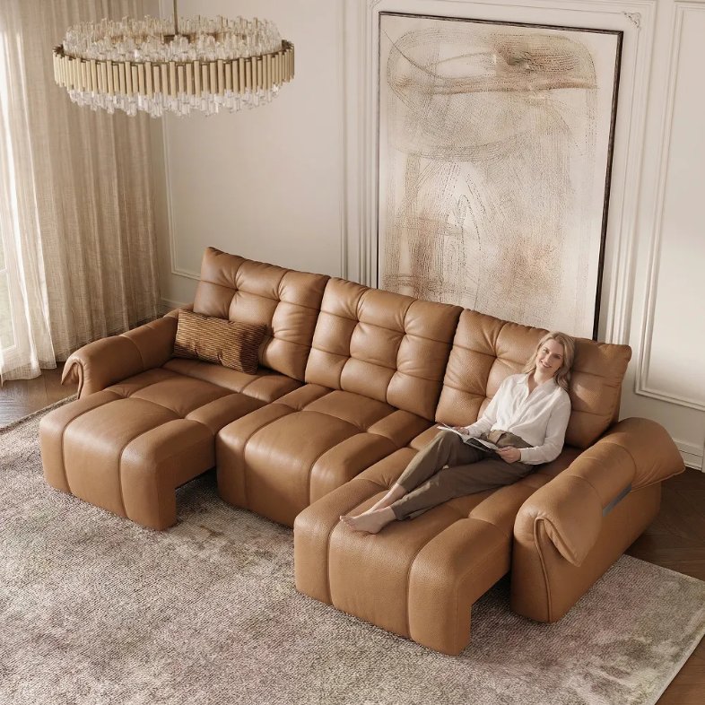 Povison Cygnus Power Sofa Bed with 3 seaters and a woman reclining in a modern living room