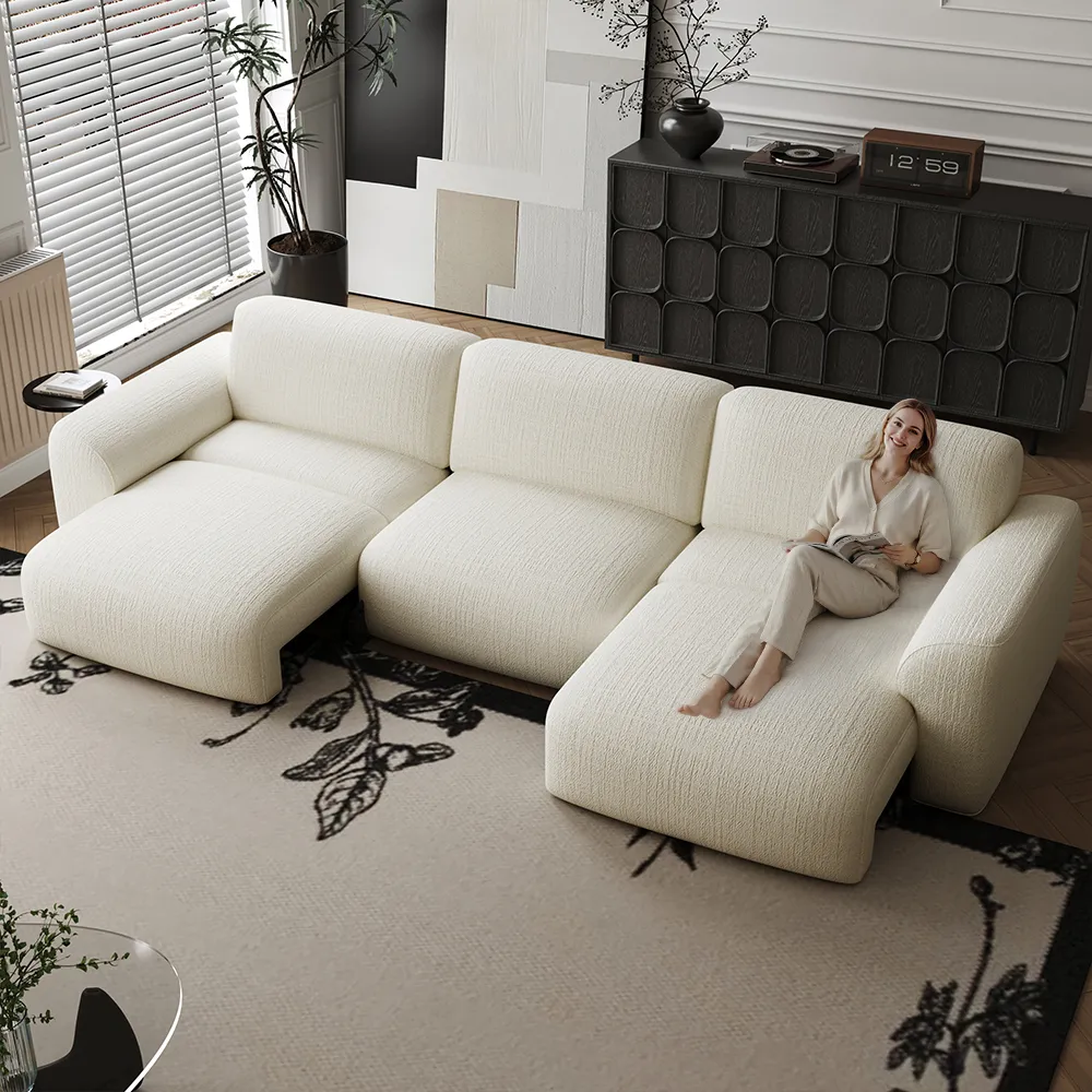Cream power sofa bed in a cozy family living room, adjusted for lounging with soft pillows, warm lighting, and relaxed seating space.