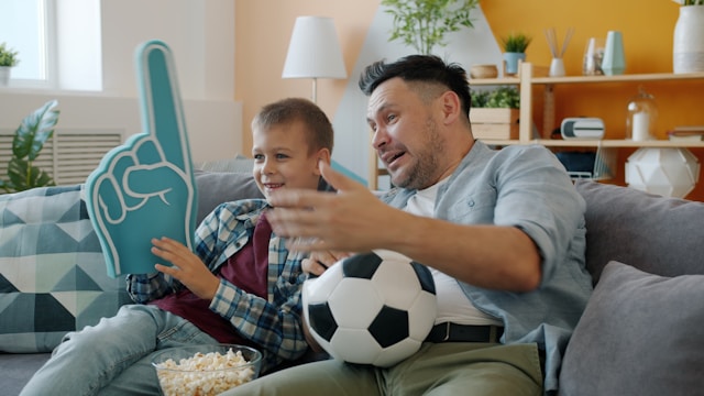 Father and son watching soccer