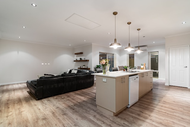 A bright open kitchen connected to a living area. The shared spaces can still feel organized and welcoming.