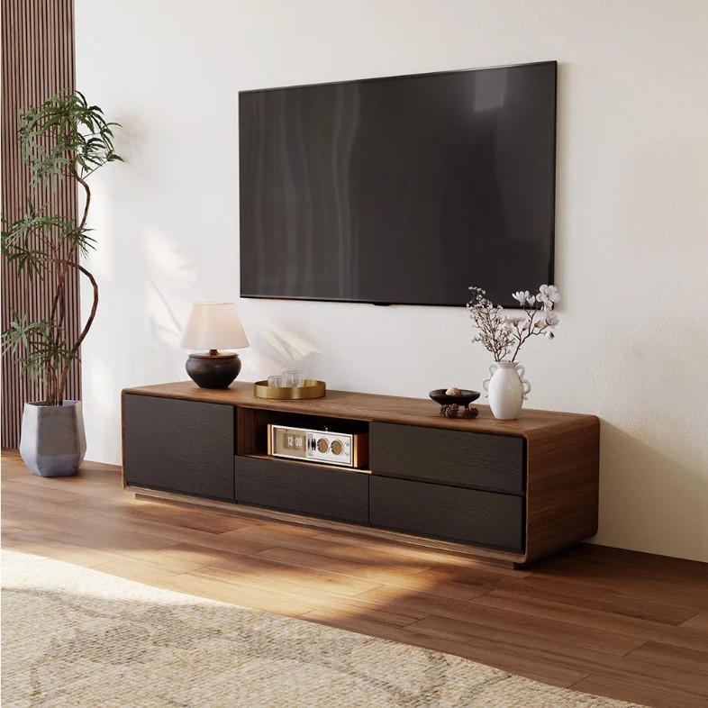 POVISON Modern Wood Black TV Stand with storage and drawers for media and a lamp, some glasses and decorations on top below a mounted tv near a plant in a cozy and bright living room