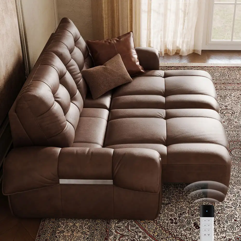 Dark brown leather power sofa bed fully extended into a lounging position, with tufted cushions, throw pillows, and a wireless remote control.