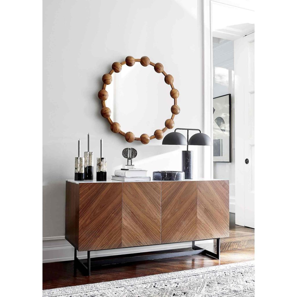CB2 Suspend 57" Walnut Wood Media Console with storage and a lamp, some books and decorations on top in a bright and modern mid-century living room