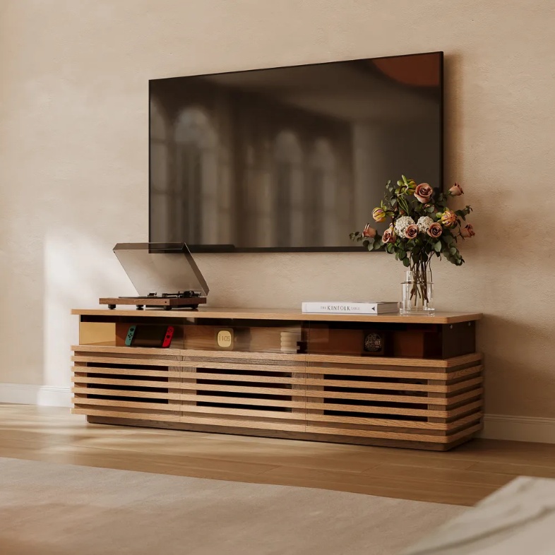 Selene-71" Horizontal Slatted TV Stand with Adjustable LED Lights, handheld game console, disc player, a book and decoration on top and a mounted tv above in a bright living room
