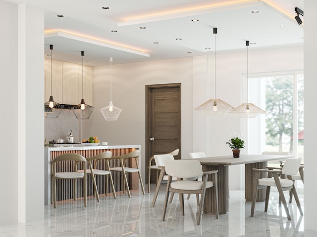 A dining and kitchen zone, showing how a table, island, and lighting can act as visual anchors.
