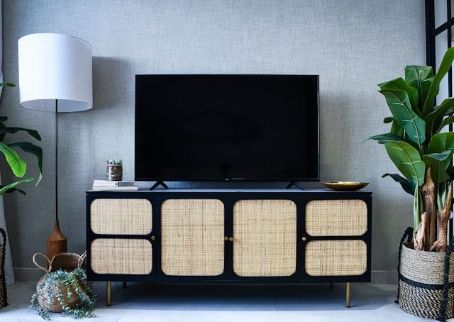 credenza with woven doors and a large television
