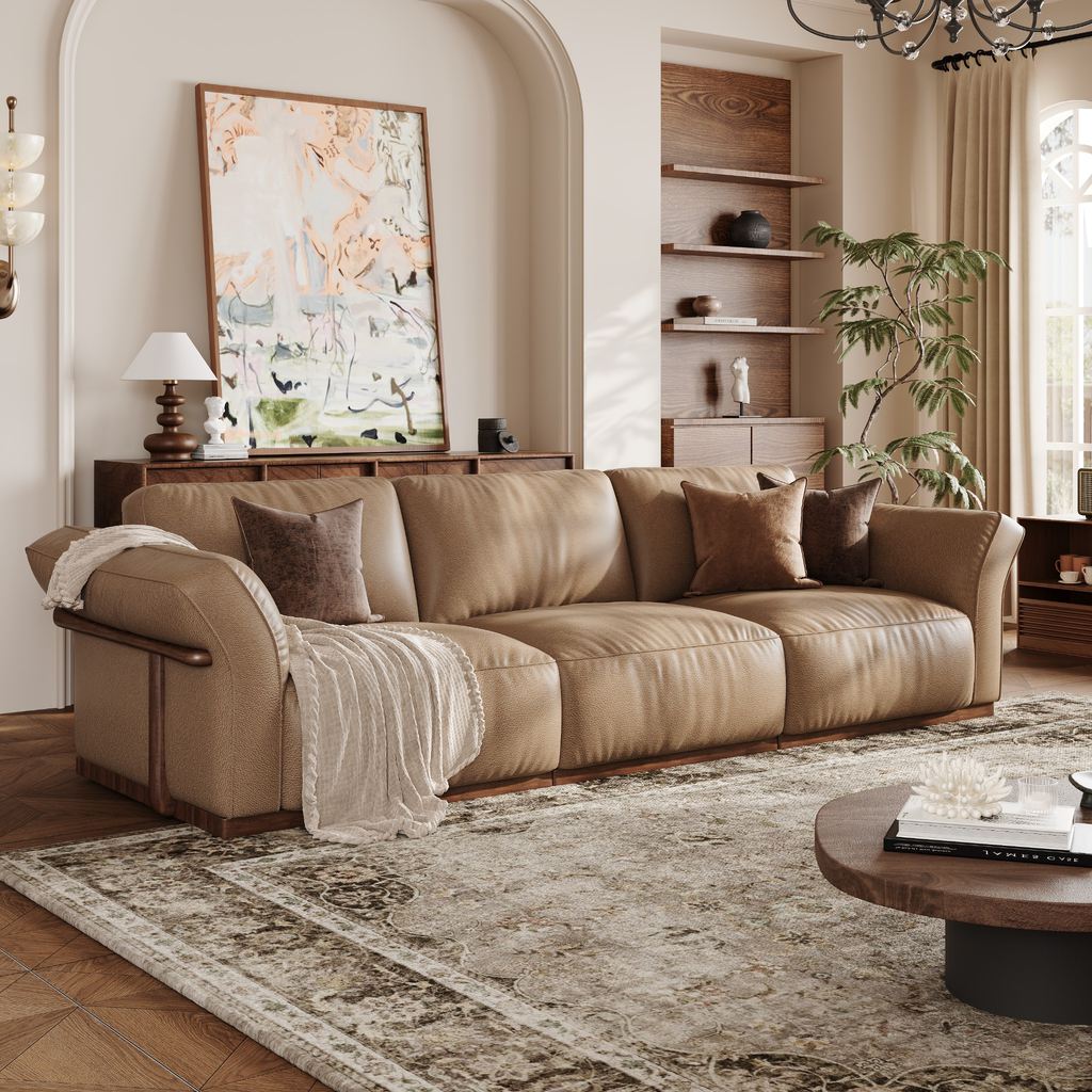Warm beige sofa in an organic modern living room with natural wood furniture, neutral textiles, and greenery