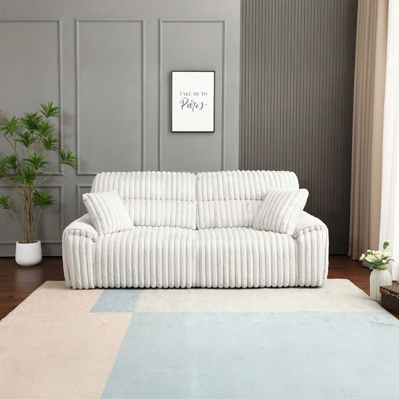 a Benjara Rasha Power Motion Recliner Sofa with Sleeper Bed and cushions near plants against a grey wall with a mounted painting in a bright and modern living room