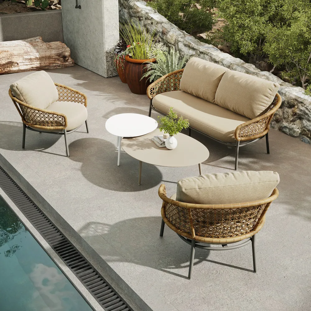Modern outdoor seating set with woven lounge chairs, a loveseat, and nesting tables arranged on a spacious patio, showcasing comfortable and stylish outdoor living.