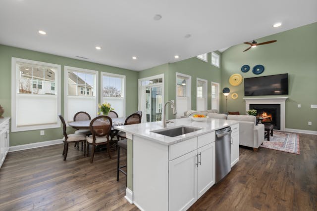 Furniture are arranged near an open kitchen, which is useful for explaining conversation areas and walkways.