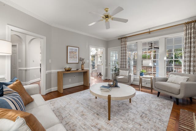 Spacious and well-lit modern living room with stylish decor and natural lighting.
