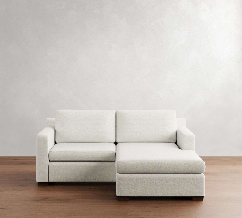 Pottery Barn Shasta Square Arm Reversible Chaise Sleeper Sectional in a bright living room against a wall