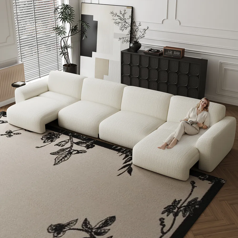 A cream sectional sofa in a bright modern living room, with two chaise sections extended for lounging.