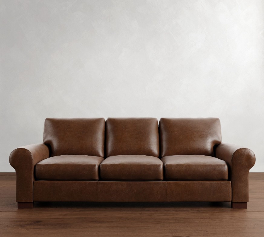 Pottery Barn Turner Roll Arm Brown Leather Sleeper Sofa in a living room