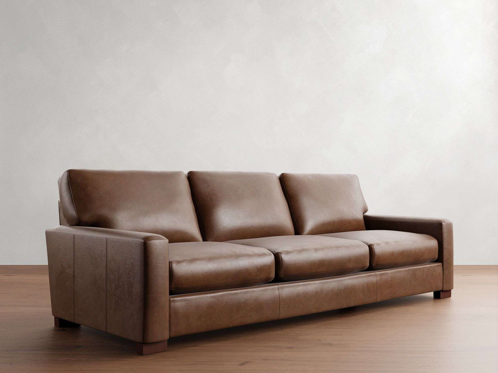 Pottery Barn Turner Square Arm Leather Sofa in dark brown in a bright and mid-century living room