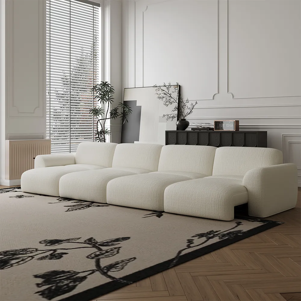 A cream modular sofa in a calm, modern living room with soft light, wood flooring, and a patterned rug. Its open layout highlights the importance of measuring furniture size, clearance, and visual balance before buying.