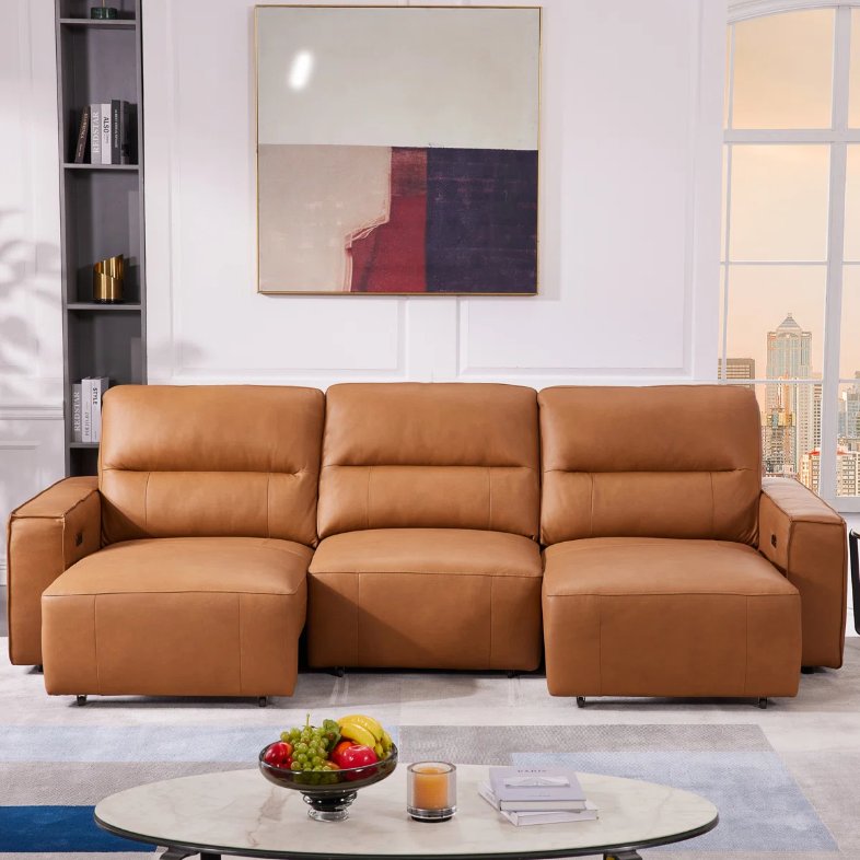 a Hokku Designs Asthon Multi-Functional Triple Electric Convertible Genuine Leather Slider Sofa with square arms near an oval coffee table against a white wall in a compact and modern living room