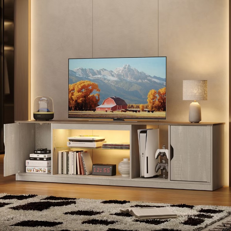 an LED Gaming TV Stand with large storage for disc, media and game play, a tv, a soundbar and a lamp on top in a warm-color living room