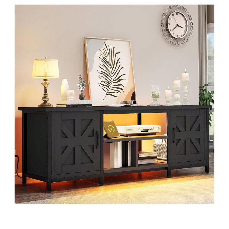 a DWVO black tv stand with large storage for media and books, LED lights and decorations on top against a grey wall in a warm and cozy living room
