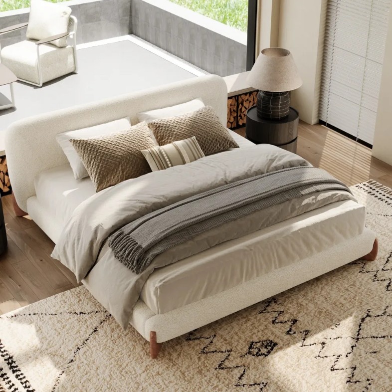 Lambra-Boucle Upholstered Bed near a round black nightstand with a lamp in a bright and modern living room